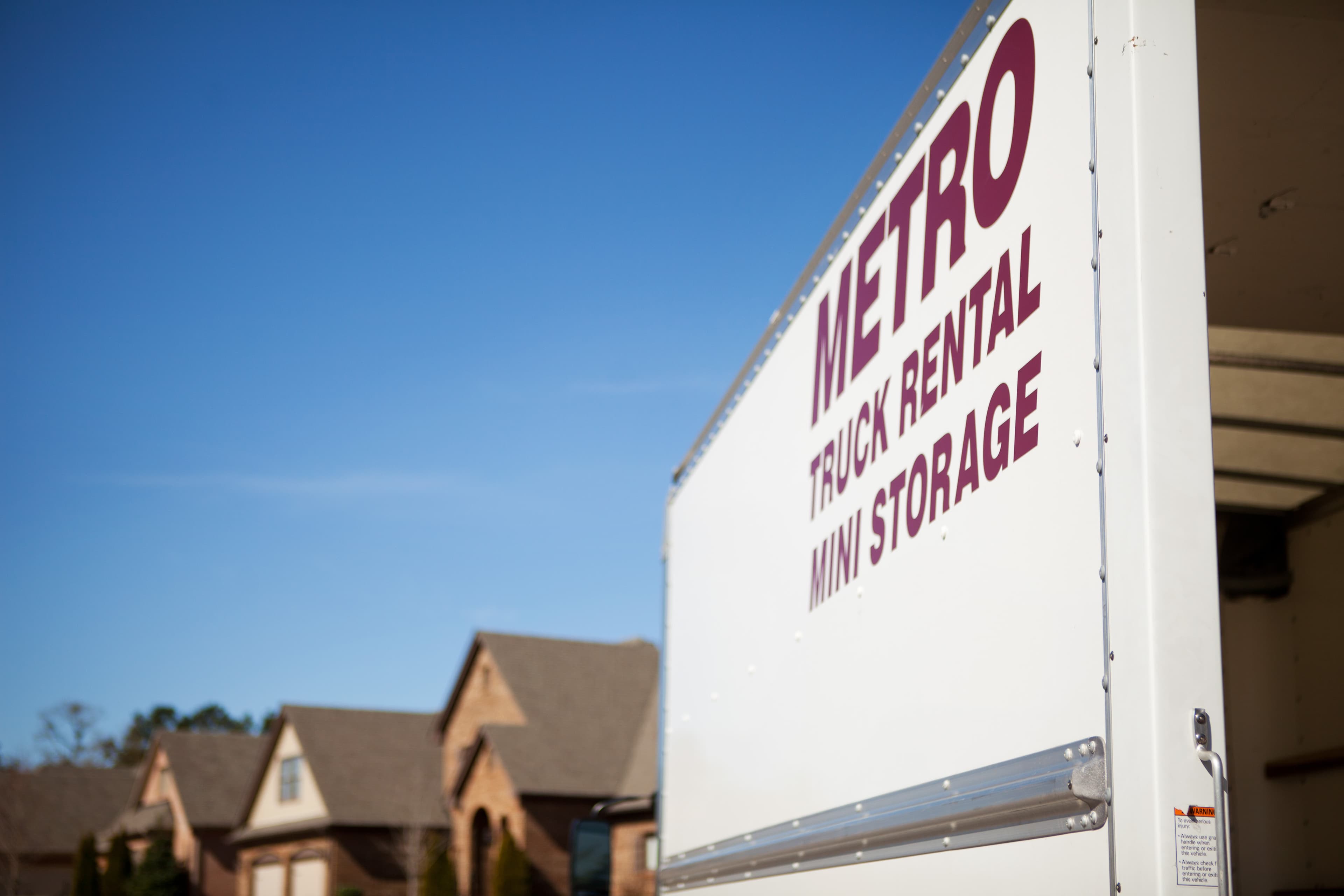 Close-up photo of the Metro Truck Rental branding on a truck box.
