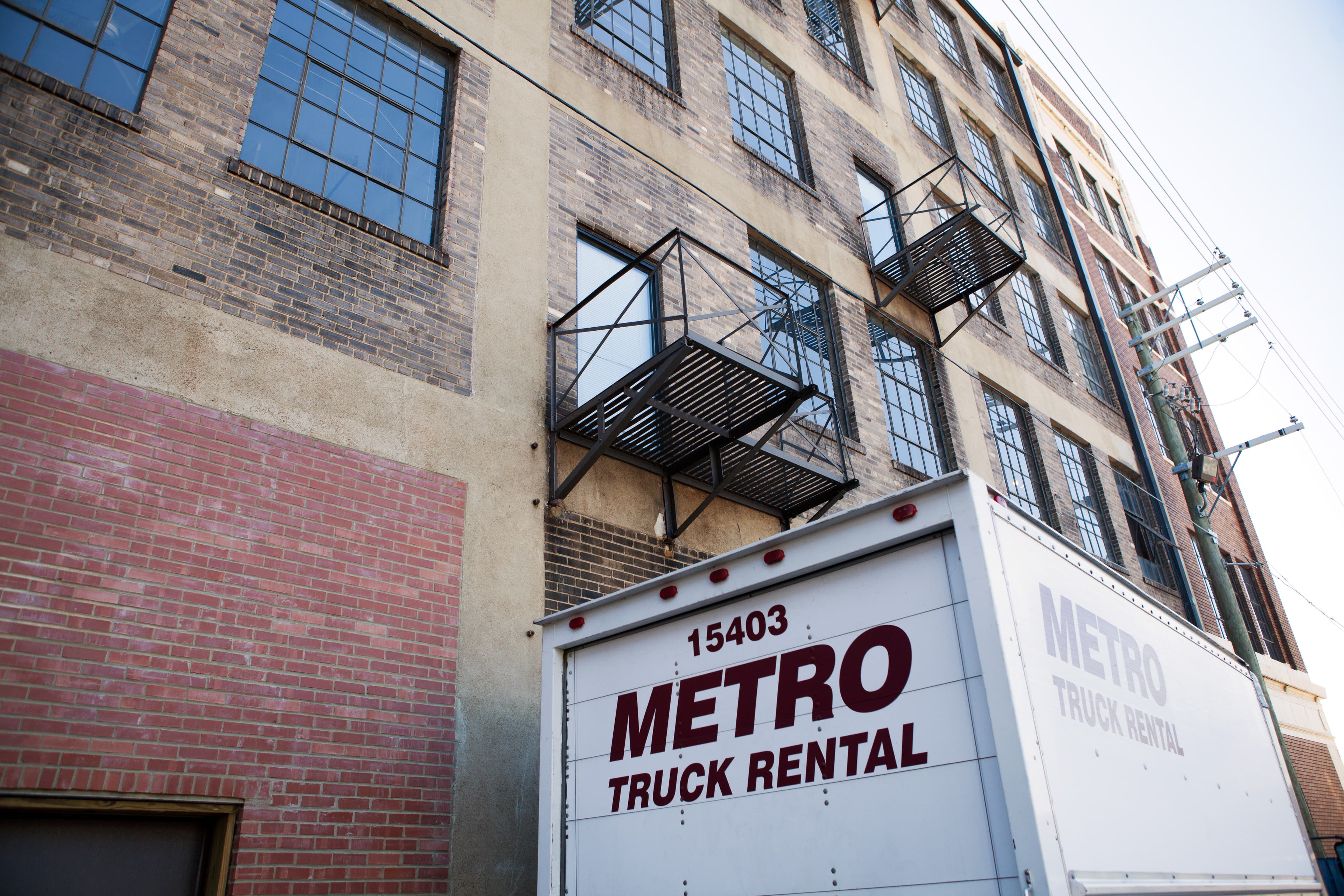 Metro truck parked in an urban setting ready for pickup.