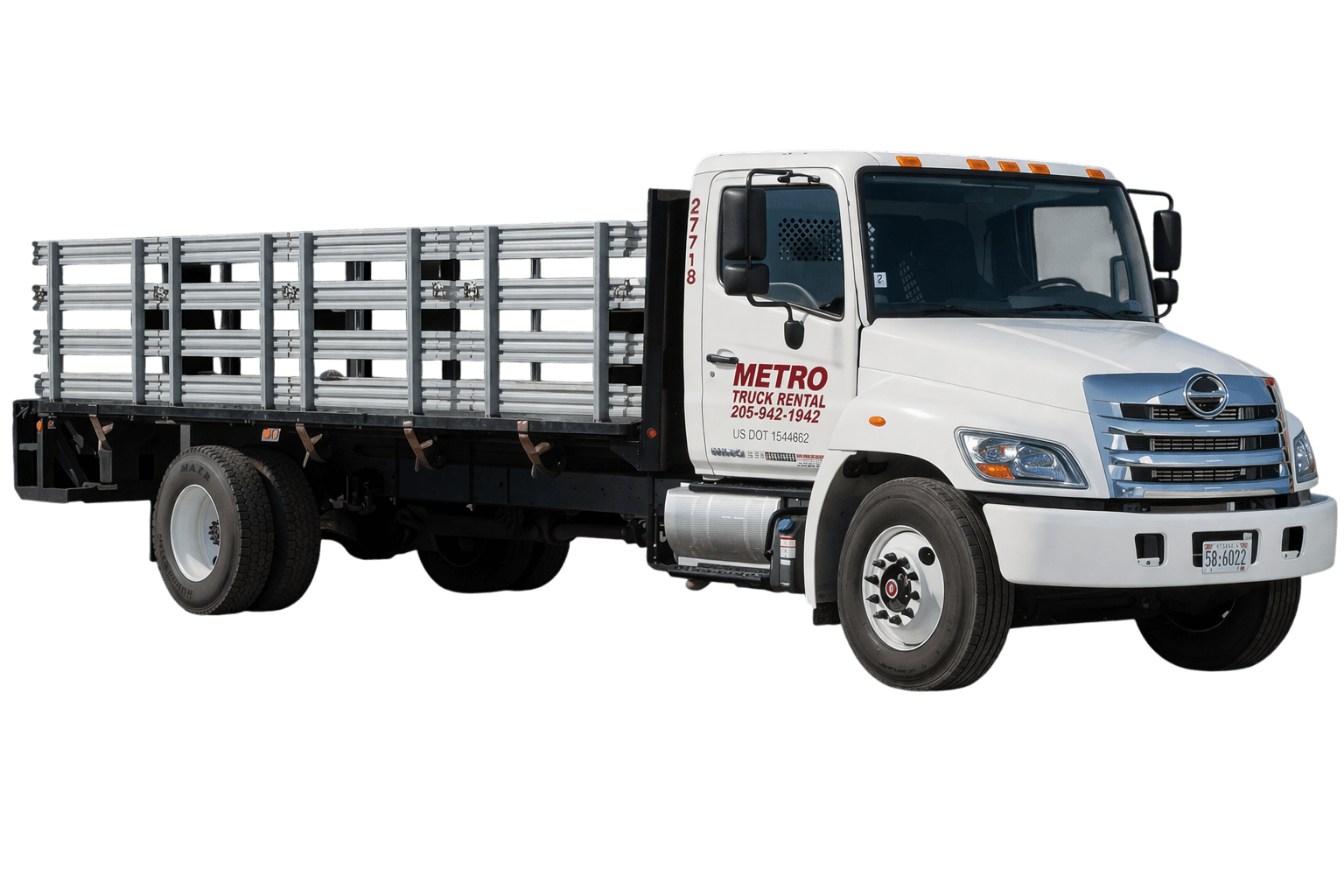 Metro stake-side flatbed truck with rails.